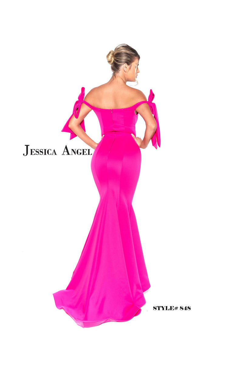 This gown features an off-the-shoulder neckline with bow detailing on both shoulders. The silhouette is fitted with scuba fabric and a slight train. This dress is playful and feminine and ideal for your next prom or formal event.  Jessica Angel 848