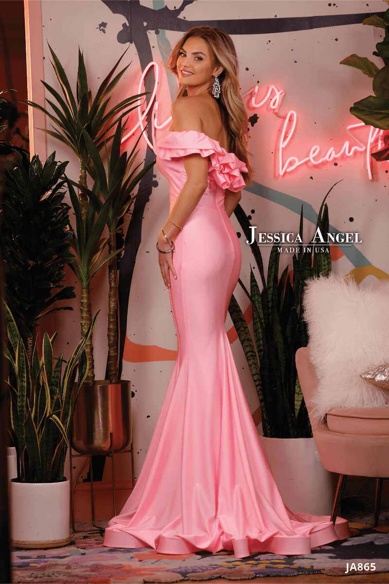 This dress features an off-the-shoulder neckline with ruffle detailing on the shoulder and back and a fitted silhouette with jersey stretch fabric. This dress is simple and stunning and could be styled to make it your own at your next prom, pageant or formal event.  Jessica Angel 865