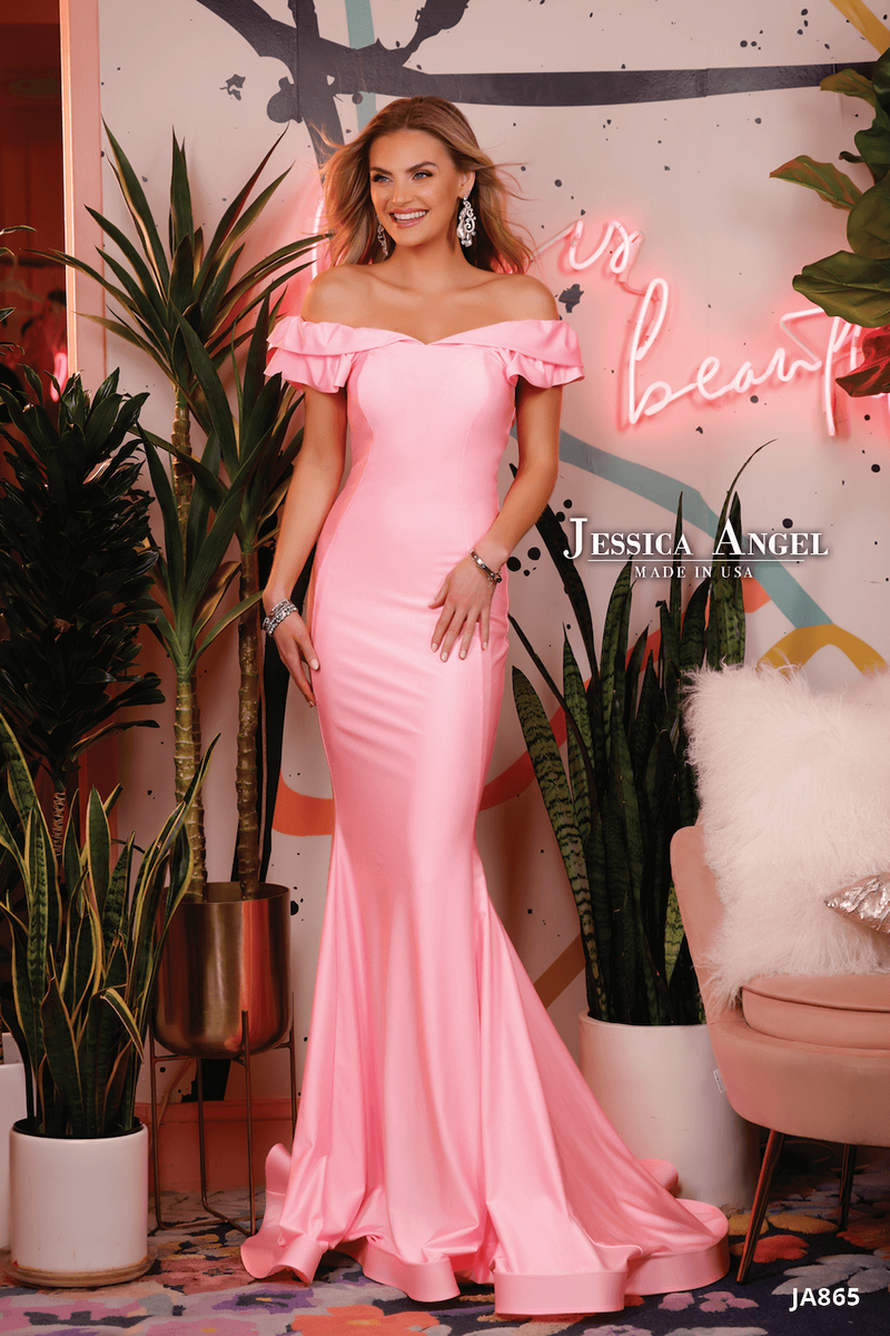 This dress features an off-the-shoulder neckline with ruffle detailing on the shoulder and back and a fitted silhouette with jersey stretch fabric. This dress is simple and stunning and could be styled to make it your own at your next prom, pageant or formal event.  Jessica Angel 865