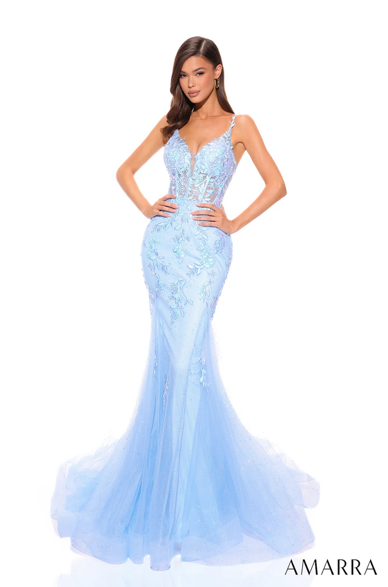 This dress features an illusion v-neckline with thin straps and a lace-up back. The bodice has corset boning with lace and sequin embellishments that trickle down the skirt. This dress has a fitted silhouette with tulle fabric. It is enchanting and unique and could be your next dream dress for prom or any formal event.   AUA 88755