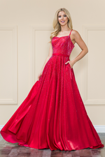 This dress features a straight across neckline with spaghetti straps and a lace-up back. It has an A-line silhouette with pockets and iridescent rhinestones throughout the vibrant fabric. This dress is effortlessly stunning and could be ideal for your next prom or formal event.  PY 8886