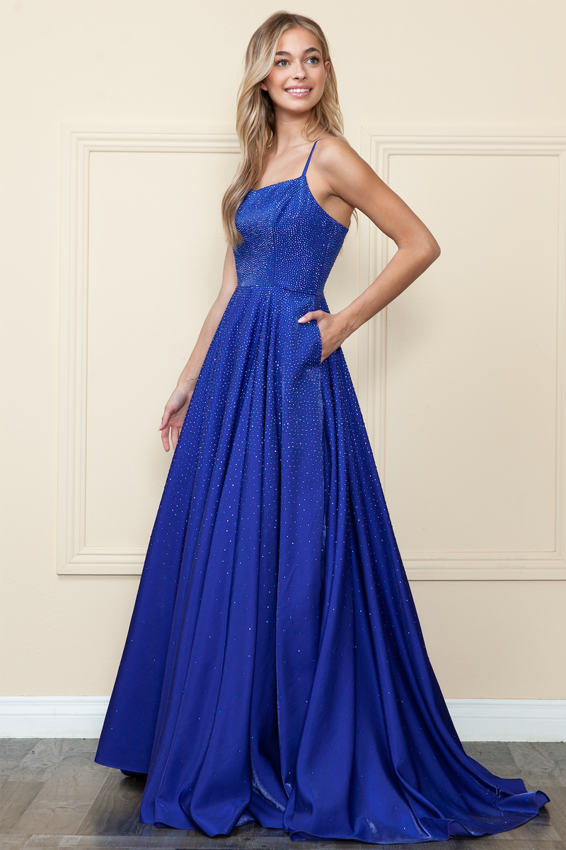This dress features a straight across neckline with spaghetti straps and a lace-up back. It has an A-line silhouette with pockets and iridescent rhinestones throughout the vibrant fabric. This dress is effortlessly stunning and could be ideal for your next prom or formal event.  PY 8886