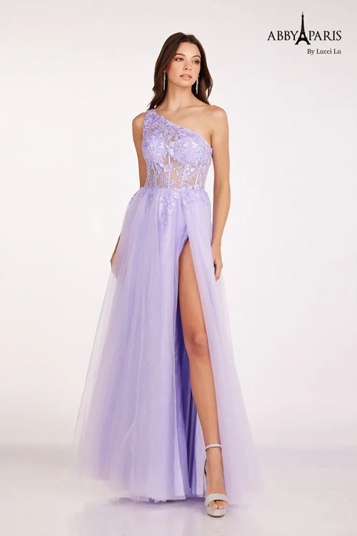 This dress features a one-shoulder neckline, a sheer bodice with corset boning and lace applique, an A-line silhouette with tulle fabric and a slit. This dress is ethereal and romantic and could be just the vibe for your next prom or formal event.   LU 90234