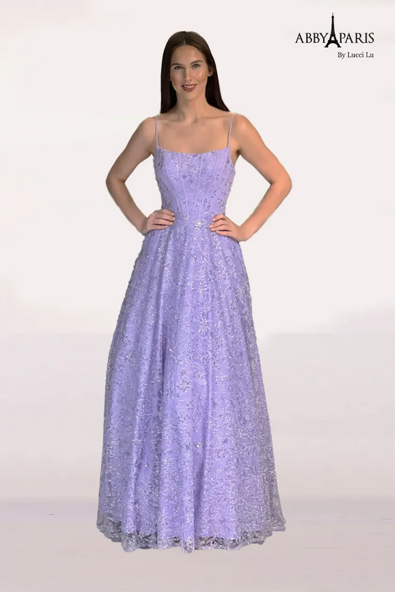 This dress features a straight across neckline with spaghetti straps, a bodice with corset boning, and an A-line silhouette. The fabric has lace and sequin detailing adding that elegance and a touch of glam. Stun at your next prom or formal event in this fairytale design.   LU 90240
