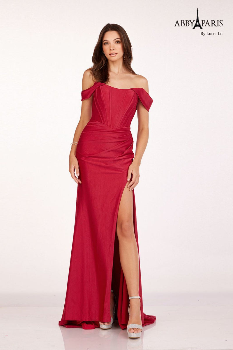 This dress features an off-the-shoulder neckline with a bodice with corset boning, a fitted silhouette and a slit. This dress is classic and elegant and ideal for your next prom or formal event.  LU 90252