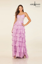 This dress features a boat neckline with spaghetti straps and a sheer bodice with corset boning. The skirt has layered tiers creating an A-line silhouette. This dress may be ideal for your next prom or formal event.

LU 90326