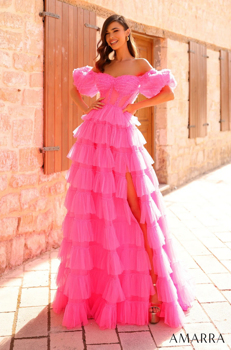 This dress is designed with accentuated ruffled details around the burst and the sheer corset bodice. The tiered tulle gown with ruffle embellishment and the off-shoulder puffed sleeves create a fun and playful vibe. With a mid-open scoop back, tulle fabric and a sweep train, this dress has all the flair to make an entrance at your next prom or formal event.  AUA 94000