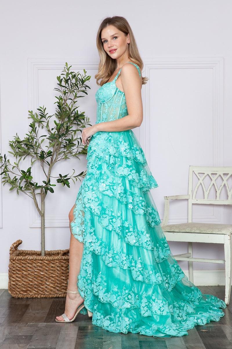 This dress features a lace corset bodice with exposed boning, an A-line silhouette with a ruffle-tiered skirt and slit. This dress is feminine and ethereal and could be just the vibe for your next prom or formal event.  PY 9410