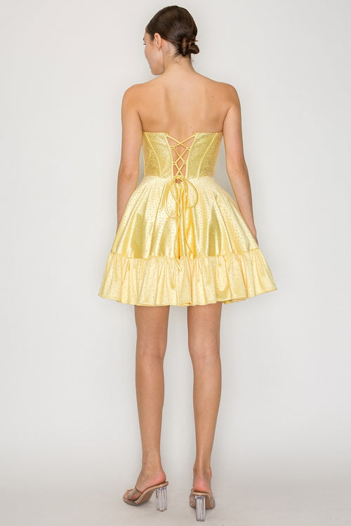 This cocktail dress features a strapless neckline with ruched detailing on the bust, with a corset style bodice with hot-stones throughout the fabric. The A-line skirt has a hem detail that creates a fun design detail.&nbsp;

PY 9942