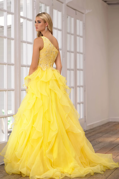 This gown features a one-shoulder neckline with a bodice embellished with sequins and crystal beading. The skirt has layered ruffle fabric which adds volume and playfulness. This gown may be ideal for your next prom or formal event.  ARY 28576
