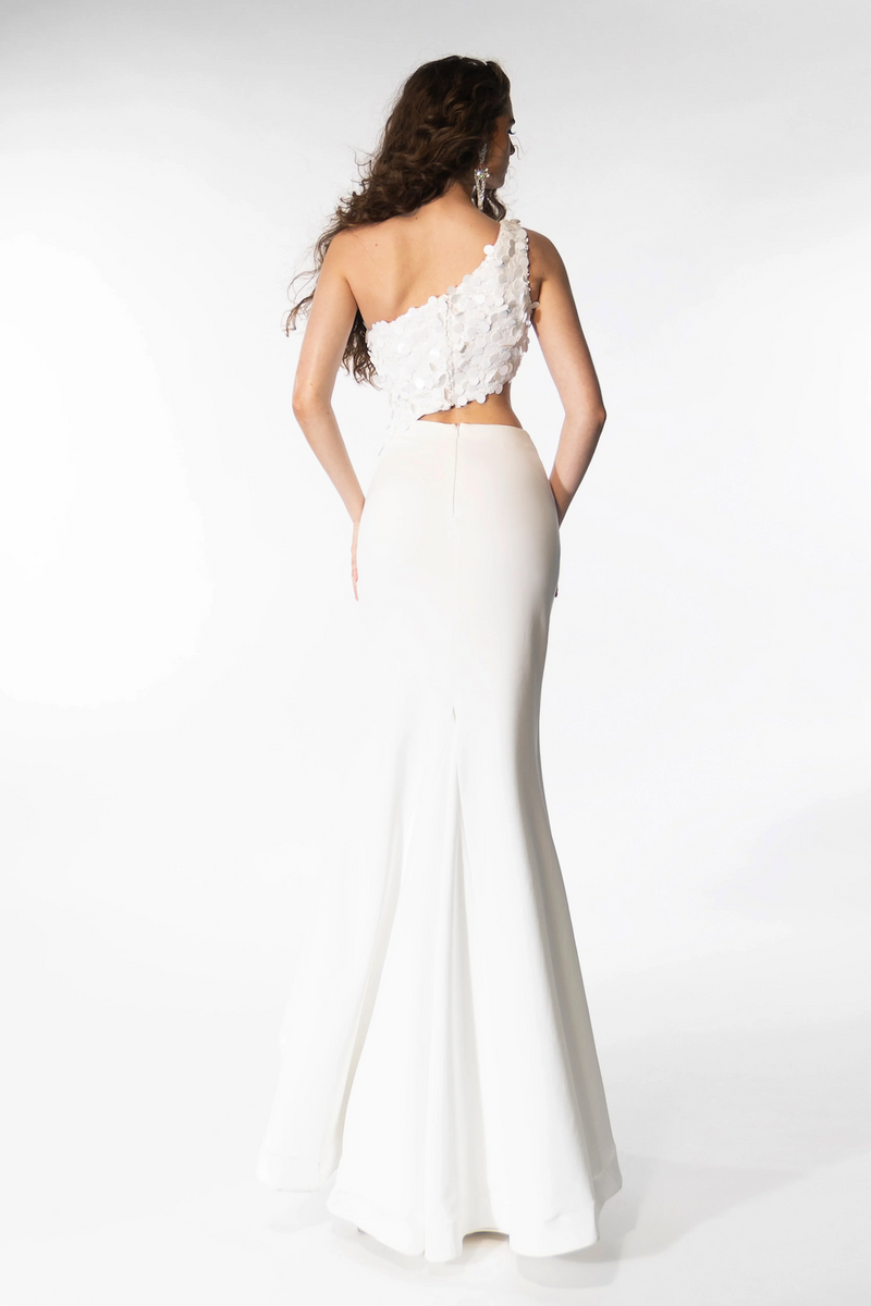 This gown features a one-shoulder neckline with a bodice embellished with large sequins. The silhouette is fitted with a slit in the skirt and a side cut-out on the waistline. This dress is unique and playful and could be perfect for your next prom or formal event.  ARY 39247