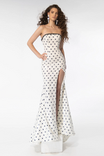 The dress features a strapless neckline with beaded applique on the top seam. The fabric is sequin-embellished with a polka dot print, a fitted silhouette with a slit in the skirt. This dress is fun and unique and could be perfect for your next prom or formal event.  ARY 39253