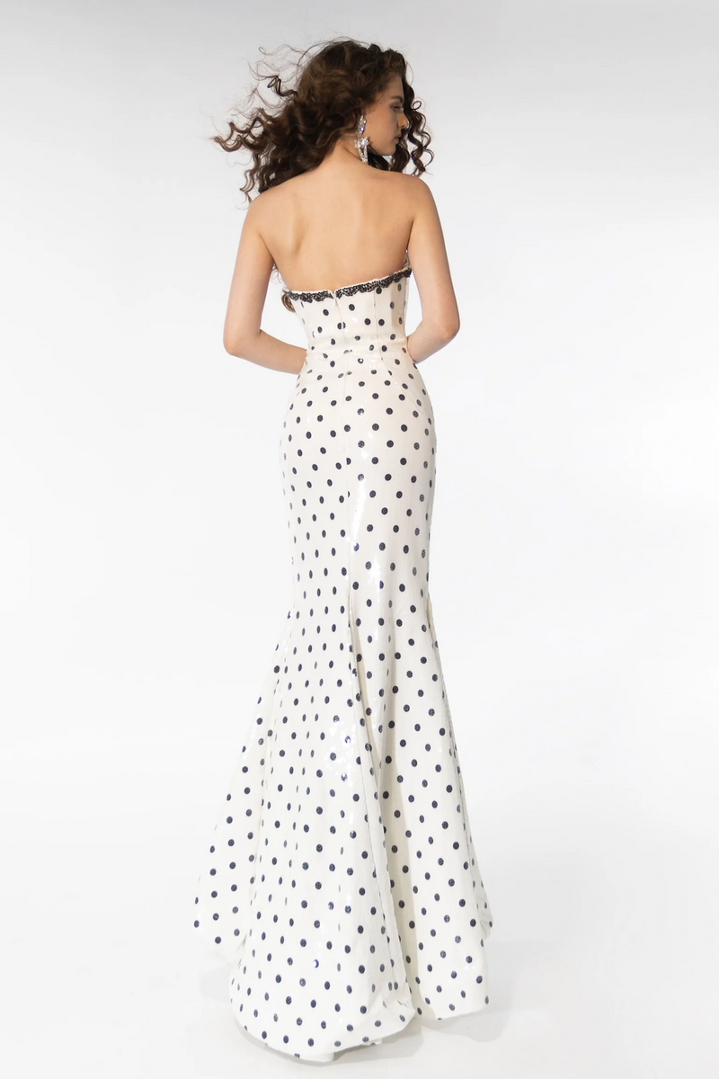 The dress features a strapless neckline with beaded applique on the top seam. The fabric is sequin-embellished with a polka dot print, a fitted silhouette with a slit in the skirt. This dress is fun and unique and could be perfect for your next prom or formal event.  ARY 39253