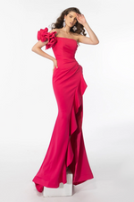 This dress features a one shoulder neckline with an embellished constructed ruffle shoulder with a fitted silhouette. The slit mirrors the shoulder with a ruffle fabric following the hemline. This gown is old Hollywood and romantic and could be just the vibe for your next prom or formal event.  ARY 39265