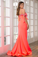 This dress features a one-shoulder neckline that falls off the shoulder with a bow detail embellished with crystal beading. The fitted silhouette has a slight train with a slit in the skirt. This dress is elegant and gives red carpet-vibes. This could be just the look for your next prom, pageant or formal event.  ARY 39304