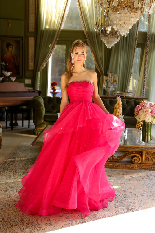 This strapless dress features a subtly crystal embellished bodice that gently flows into a layered, full skirt, perfect for creating a soft and romantic silhouette. Whether for a prom, or any formal occasion, this gown exudes grace and sophistication all night long.

ARY 29524