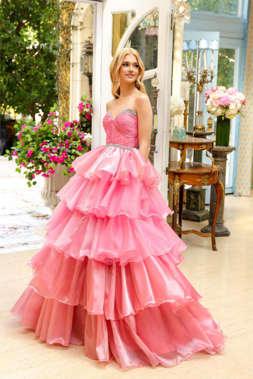 Featuring a sweetheart neckline adorned with delicate crystal embellishments, this gown’s tiered layers create a dramatic, voluminous effect that’s perfect for any prom, pageant or formal event.  ARY 29546