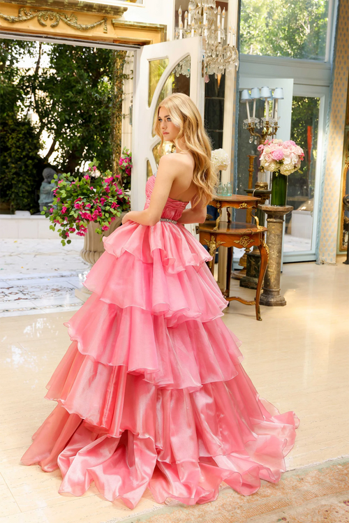 Featuring a sweetheart neckline adorned with delicate crystal embellishments, this gown’s tiered layers create a dramatic, voluminous effect that’s perfect for any prom, pageant or formal event.  ARY 29546
