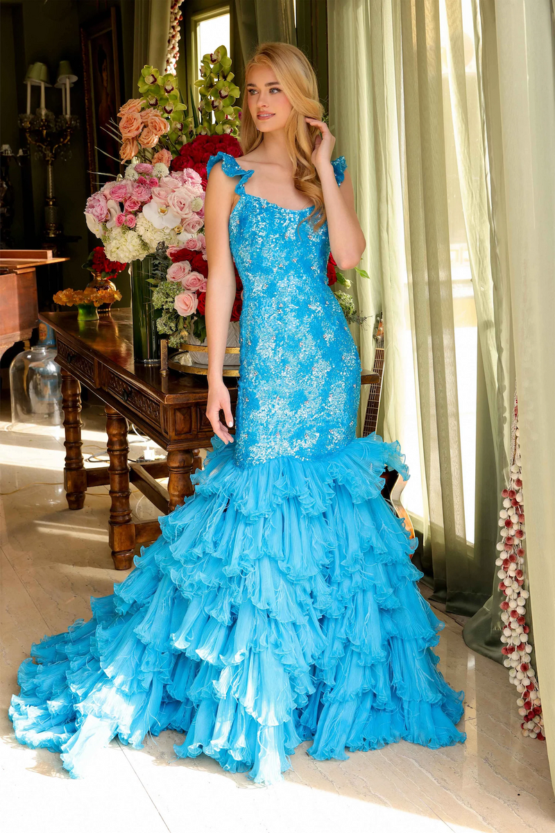 This stunning mermaid gown features a shimmering sequin bodice that flows effortlessly into a dramatic tiered ruffle skirt. The perfect choice for making a statement at pageants or at your next formal event.

ARY 39551