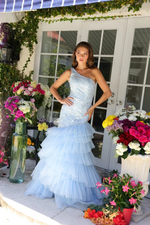 This dress features a one-shoulder neckline with a bodice crafted from lace fabric that adds a touch of sparkle.&nbsp;The skirt features layers of tiered tulle ruffles that cascade down, creating a voluminous silhouette. Perfect for formal events, this dress is ideal for your next prom or pageant.

ARY 29254