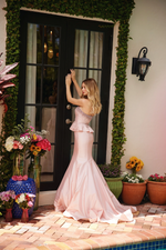 This strapless dress features a fitted bodice embellished with intricate beading. A peplum detail at the waist enhances the silhouette, creating a flattering hourglass shape. The gown flows into a mermaid-style skirt, flaring out toward the hem. Perfect for formal events such as prom, or your next pageant.

ARY 40092