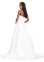 This mikado fabric ballgown features a strapless bodice with intricate pleating and a dramatic overskirt with a front slit. This dress is simple but elegant and could be ideal for your next prom or pageant.

Ashley Lauren 12056