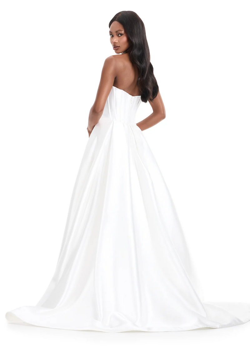 This mikado fabric ballgown features a strapless bodice with intricate pleating and a dramatic overskirt with a front slit. This dress is simple but elegant and could be ideal for your next prom or pageant.

Ashley Lauren 12056