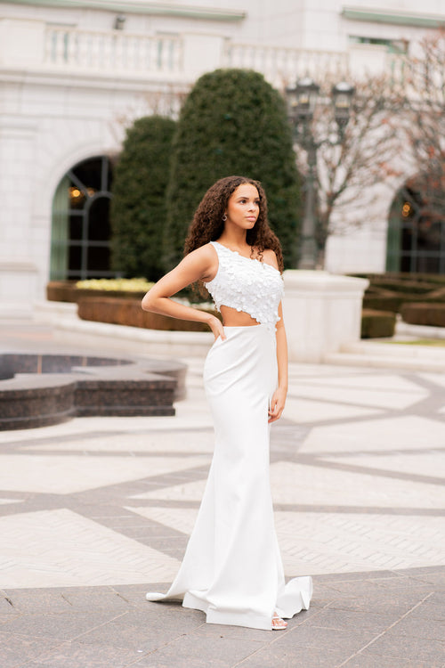 This gown features a one-shoulder neckline with a bodice embellished with large sequins. The silhouette is fitted with a slit in the skirt and a side cut-out on the waistline. This dress is unique and playful and could be perfect for your next prom or formal event.  ARY 39247