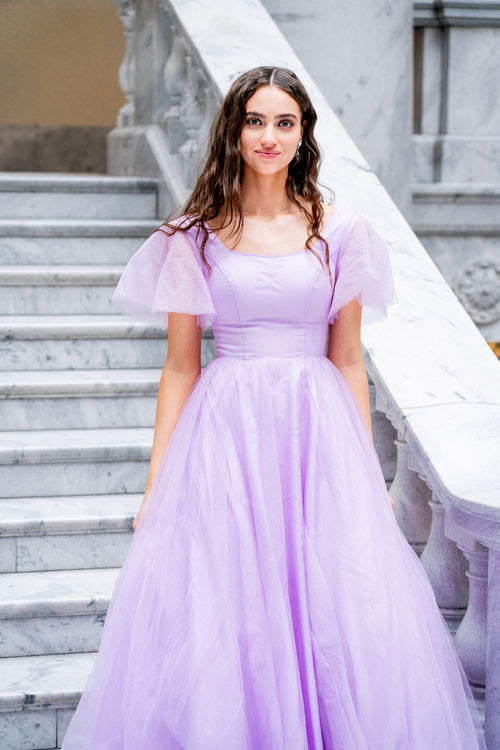 This dress features a square neckline with tulle short sleeves and a back that mirrors the front. This dress has an A-line silhouette and is a great choice for your prom if you are looking for a dress with a bit more coverage. Modest prom dress. JAD J24008SP