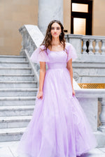 This dress features a square neckline with tulle short sleeves and a back that mirrors the front. This dress has an A-line silhouette and is a great choice for your prom if you are looking for a dress with a bit more coverage.  JAD J24008SP