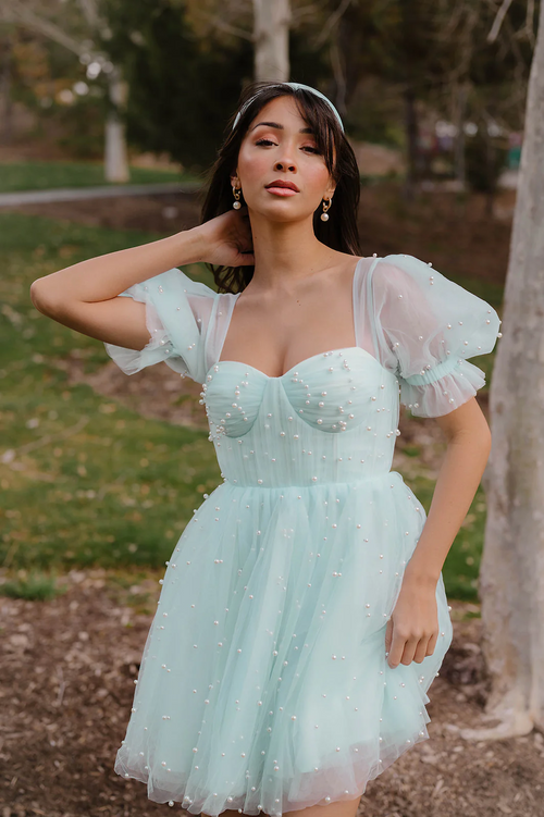 Made from high quality tulle, this mini dress is covered in hand-placed pearls. It features double-lined tulle sleeves and a corset-style top in a mini length and lace-up back. This may be the perfect dress for your next homecoming or formal event.

AG 11008
