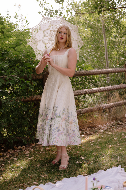 This tea length gown features a brocade foil design, a corset-style top with hidden cups, pockets, and thick straps with a full zippered back. Style this dress to make it your own at your next homecoming or formal event!

AG 11009