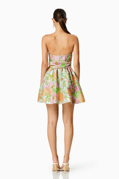 This cocktail dress features a fully boned bodice with cup detail, a flared mini skirt with a gathered waist and a separate belt tie. The large scale floral jacquard fabric is unique and could be just the vibe for your next homecoming or formal event.    ELT EC8052409