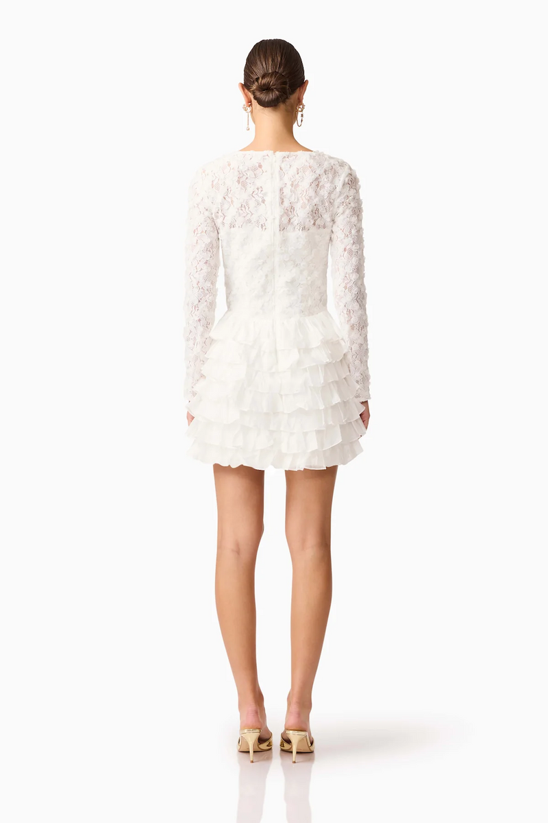 This long sleeve mini dress with a fitted silhouette features frills on the hip for a soft, sculptural accent with lace/tencel organza fabrication for texture. This modest cocktail dress is an excellent choice for your next homecoming or formal event.

ELT EH3092540