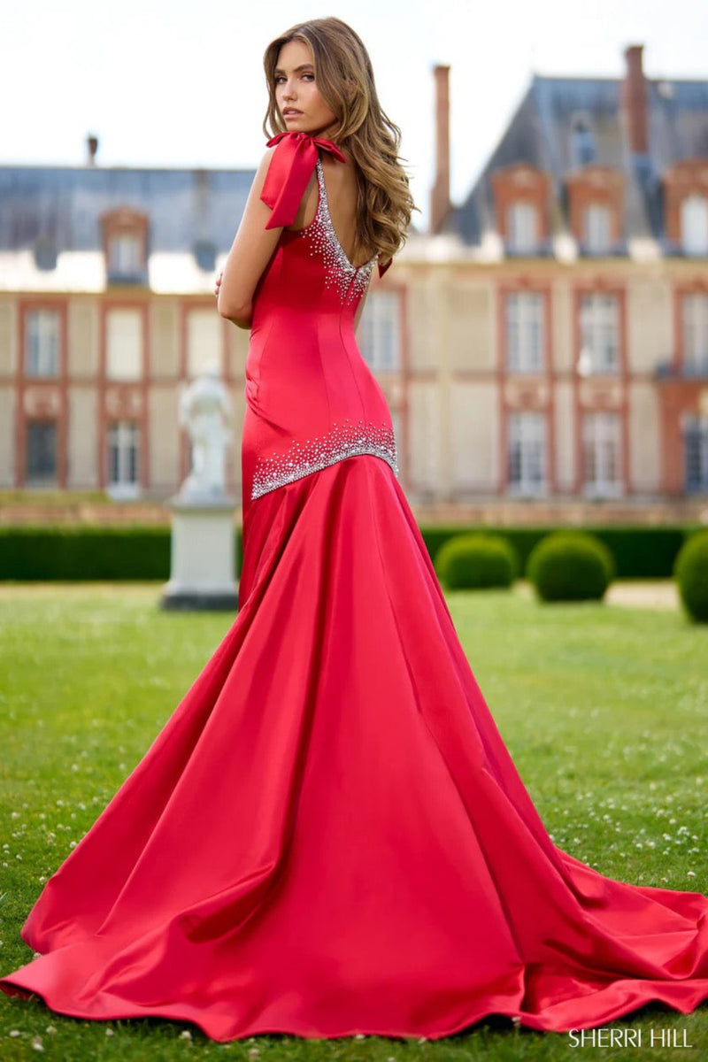 This Sherri Hill gown features satin fabric, a mermaid silhouette, with bead embellishments, and bows on the sleeves. This dress is perfect for your next pageant or red carpet event.&nbsp;

Sherri Hill 56996&nbsp;