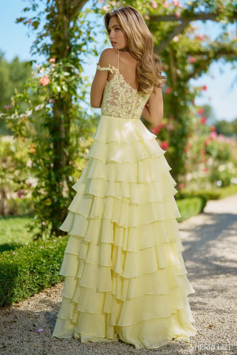 This Sherri Hill gown features a leaf lace corset top, with delicate leaf lace straps, and a chiffon ruffle skirt with a slit. A stunning choice for your next prom or pageant.&nbsp;

Sherri Hill 56868
