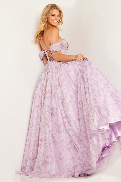 This dress features an off-the-shoulder neckline paired with a deep v bodice with ruched detailing and corset boning. The back has a lace-up closure, and the fabric features a printed floral design with stones scattered throughout the skirt all in a chiffon fabric. Choose this stunning ballgown for your next prom or formal event.   Jovani JVN36581A
