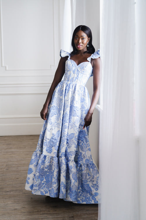 This dress features a sweetheart neckline with spaghetti straps with a ruffle detail, a corset style bodice and brocade fabric. This is a romantic choice for your next prom or formal event.

AG 11002