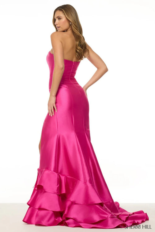 This strapless gown features mikado fabric, a mermaid silhouette, and a tiered ruffle slit skirt. Pair with some sparkly statement earrings for the perfect prom look!&nbsp;

Sherri Hill 57019