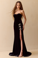 This stunning gown features a fitted silhouette, strapless neckline, velvet fabric and beaded bow accents along the slit of the dress. Add a pair of sparkly heels for your next pageant or formal event look.

ACE 8047