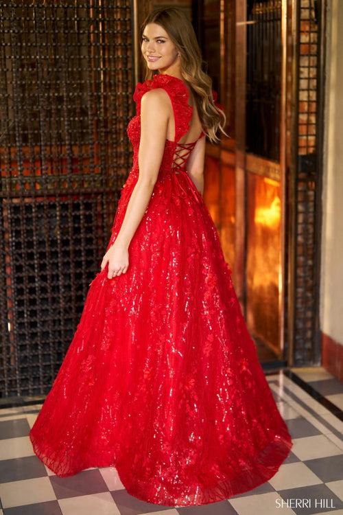This Sherri Hill gown features a ballgown silhouette, sequin lace with corset bodice, ruffle sleeves and a lace up back. Pair with some simple heels for the perfect prom look.

Sherri Hill 56673