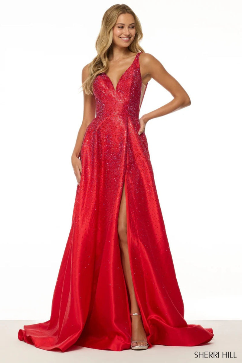 This Sherri Hill gown features an A-line silhouette, hot pressed stones, with sheer sides and slit in the skirt. Pair this dress with some daring earrings for you next prom or formal event.&nbsp;

Sherri Hill 56990