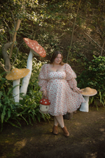 Crafted from a soft fabric featuring an enchanting mushroom print, this dress adds a touch of whimsy to your style. With long puffy sleeves, a cinched waist, and a lace-up back, this could be the ideal dress for your next homecoming or formal event.

AG 11005