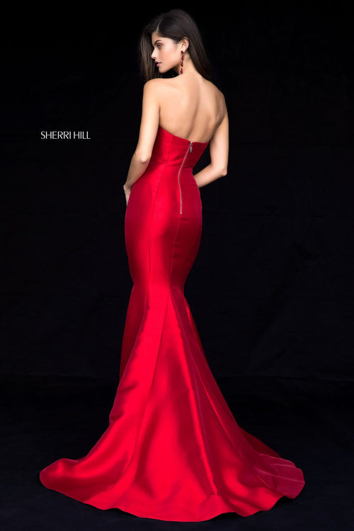 This Sherri Hill gown features a strapless neckline, mikado fabric and a mermaid silhouette with a slit skirt and train. This dress is a forever classic and will never go out of style. Choose this beauty for your next prom or formal event!  Sherri Hill 51671