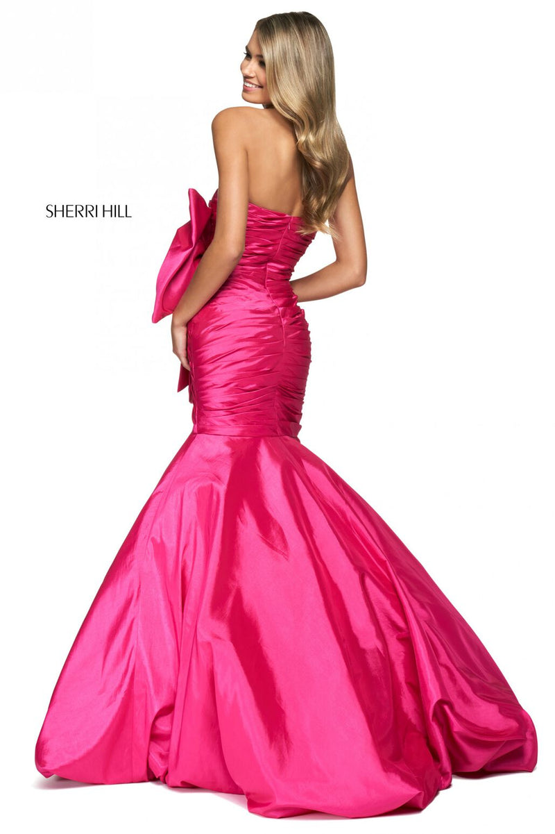 This Sherri Hill dress features taffeta fabric with a mermaid silhouette, a strapless neckline, pleated bodice and large embellished bow on the hip. This one-of-a-kind dress may be the perfect fit for your next prom or formal event.   Sherri Hill 54027