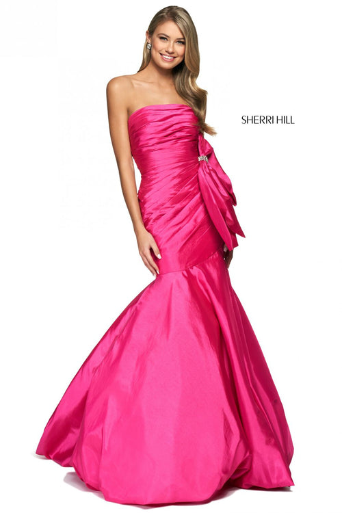 This Sherri Hill dress features taffeta fabric with a mermaid silhouette, a strapless neckline, pleated bodice and large embellished bow on the hip. This one-of-a-kind dress may be the perfect fit for your next prom or formal event.   Sherri Hill 54027