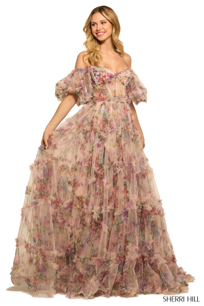 <p><span>This gown features tulle floral print fabric with a sheer corset bodice with ruffle embellishments and balloon sleeves. The neckline is off-the-shoulder, with a belt tie along the waistline and the skirt has ruffle detailing throughout. This dress has a romantic, boho-vibe which may be perfect for your next prom or formal event.</span></p> <p>Sherri Hill 55541</p>