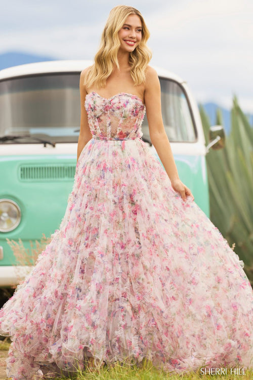 <p><span>This strapless gown features floral tulle print fabric with ruffle embellishments throughout the bodice and skirt. The sheer bodice has corset boning with a tie along the waistline. This dress is boho and romantic and could be perfect for your next prom or formal event.</span></p> <p>Sherri Hill 55623</p>