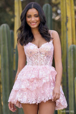 This cocktail dress features tulle sequin fabric with sheer corset bodice, sweetheart neckline, and ruffled tiered skirt.   Sherri Hill 55804