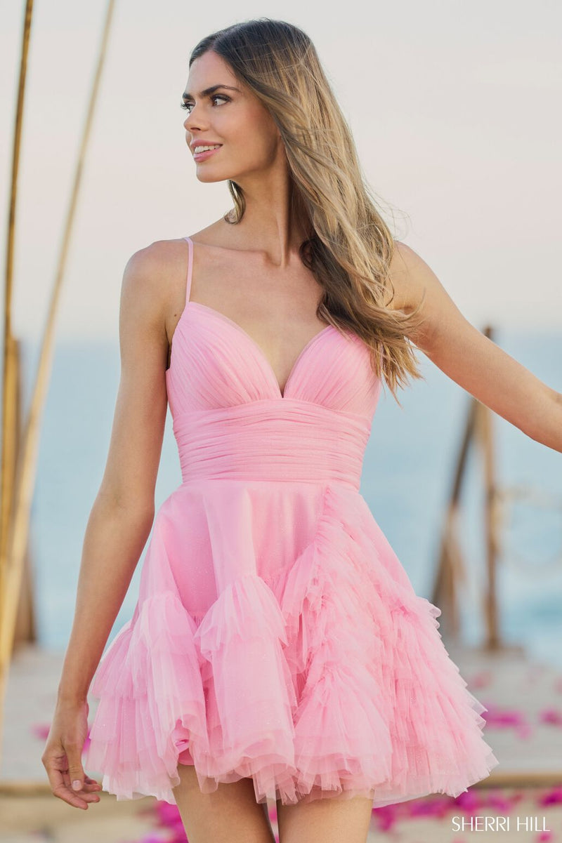 This Sherri Hill dress is the perfect balance of simple but not basic. It features tulle fabric with ruffle details, a sweetheart neckline and spaghetti straps.  Sherri Hill 55818